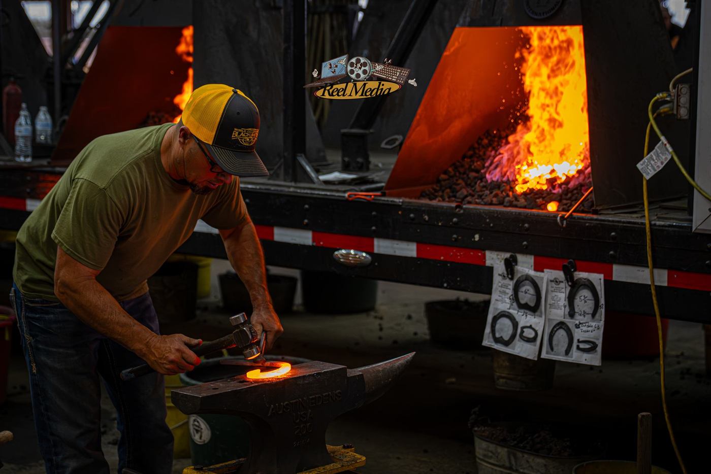 A smith shaping metal on the anvil
