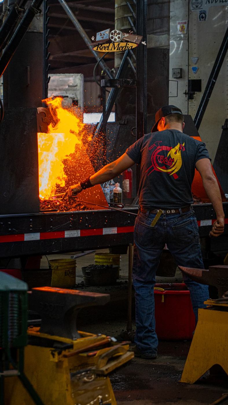 A smith silhouetted against the forge glow