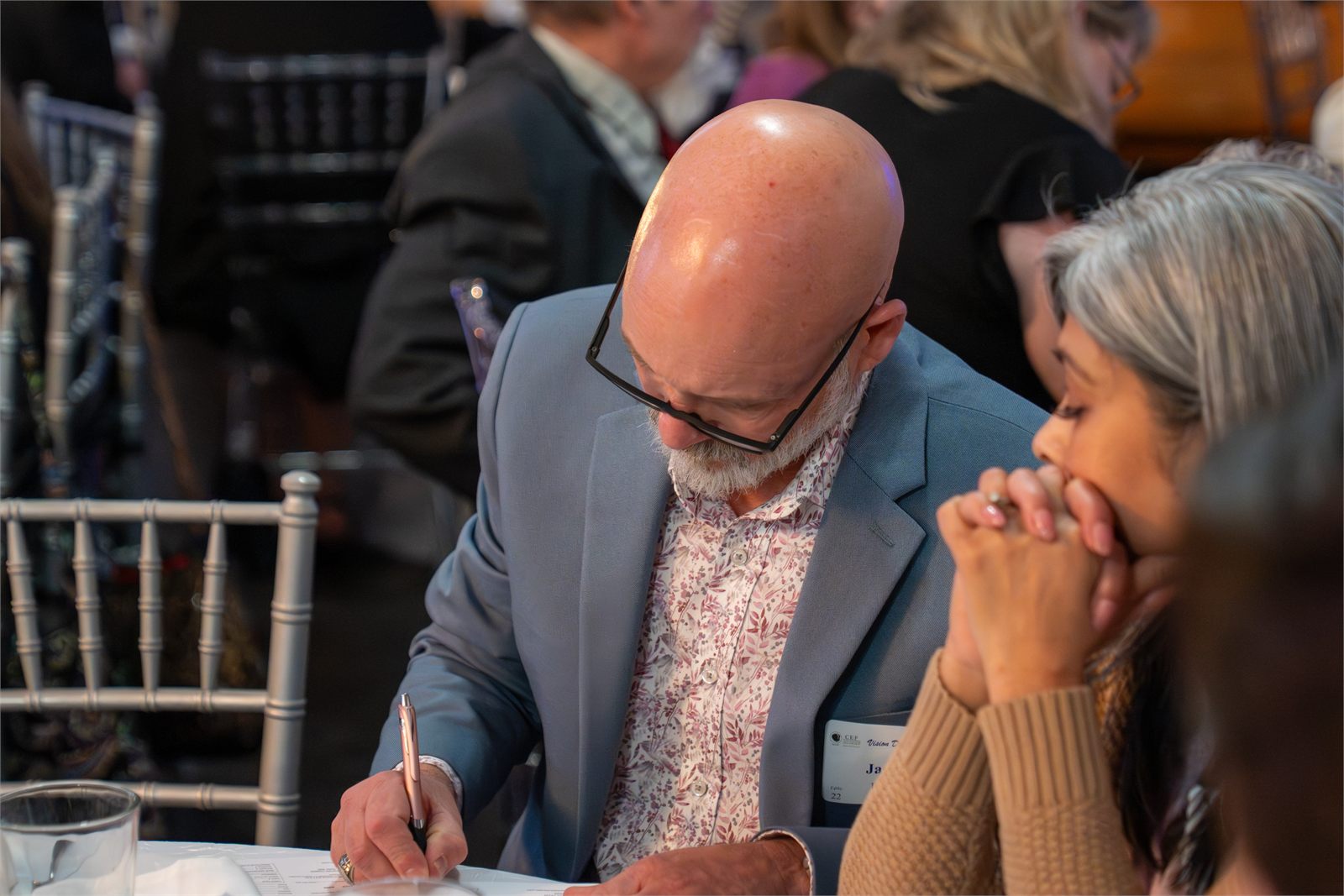 A guest filling out a pledge card