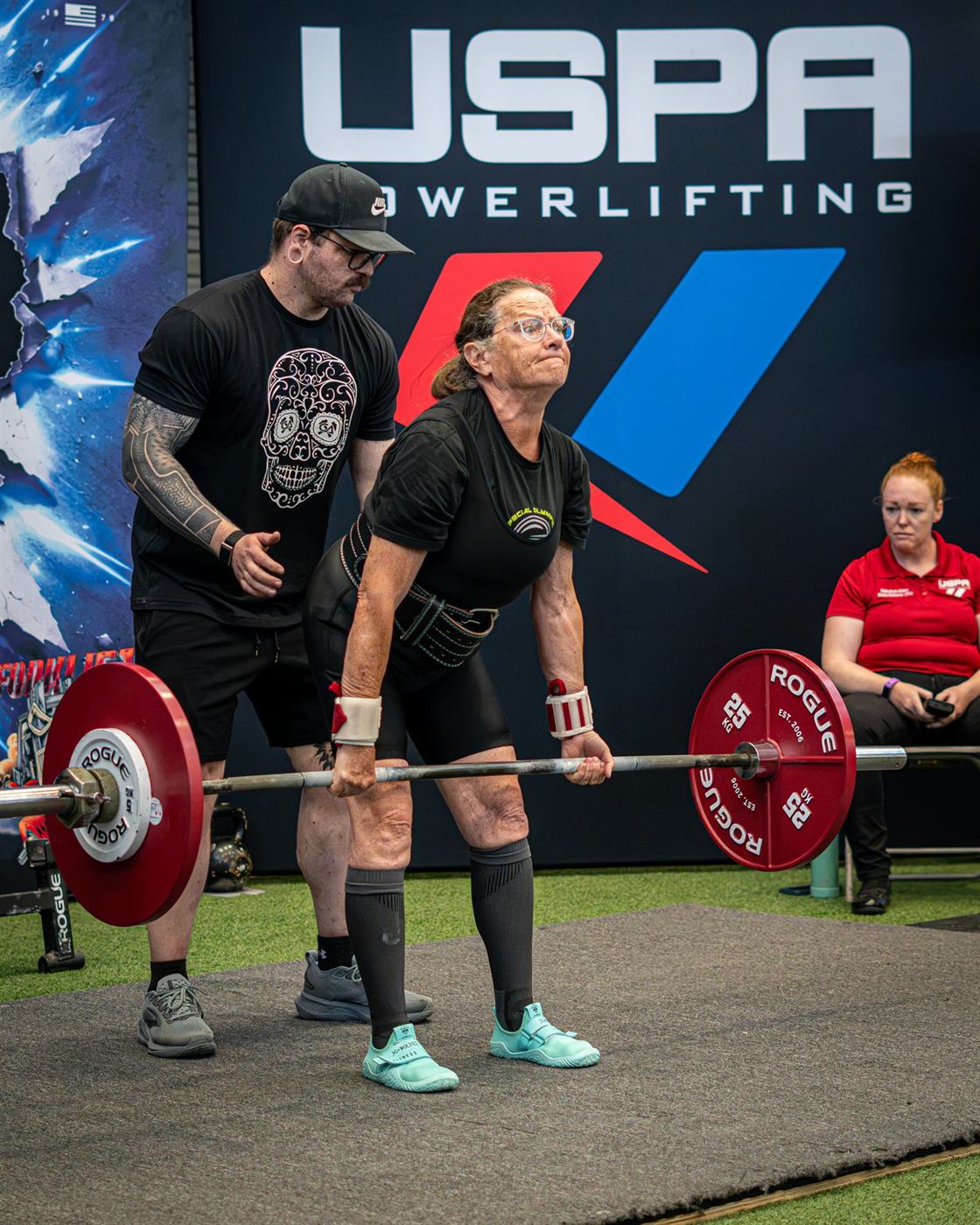 A lifter finishing a deadlift