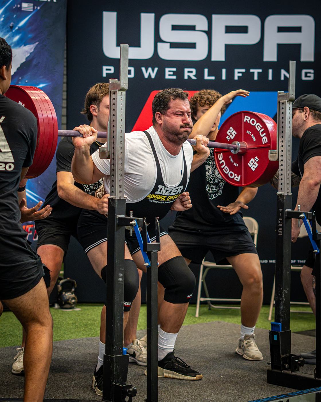 A lifter driving out of the hole on a squat